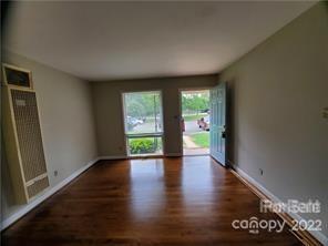 3838 Tuckaseegee Road Charlotte, NC 28208 - Photo 4 of 9 a view of an empty room with wooden floor and a window