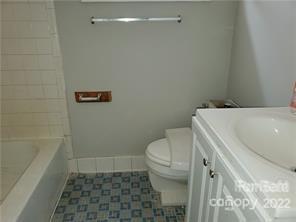 3838 Tuckaseegee Road Charlotte, NC 28208 - Photo 7 of 9 a bathroom with a sink a toilet and shower