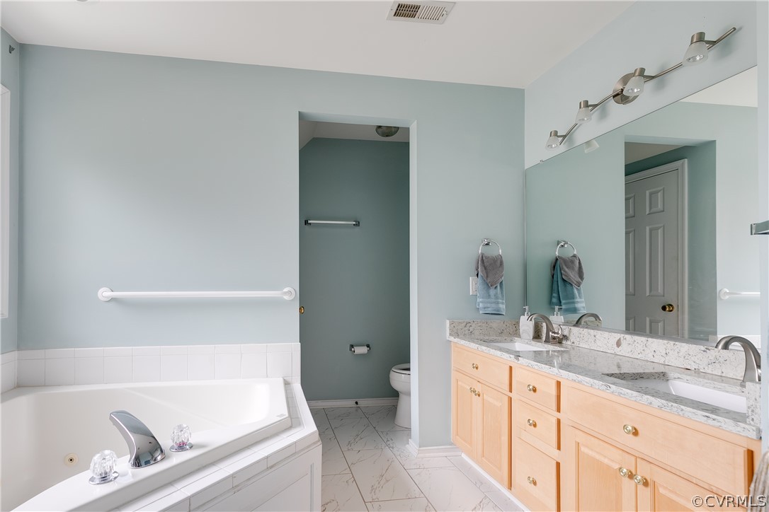1101 Goswick Ridge Road Midlothian, VA 23114 - Photo 28 of 34 a bathroom with a tub sink and mirror