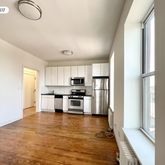 a view of kitchen with microwave a stove and cabinets