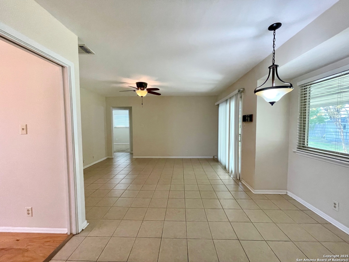 6714 Straw Flower Street Leon Valley, TX 78238 - Photo 11 of 23 a view of a livingroom with a chandelier fan and windows