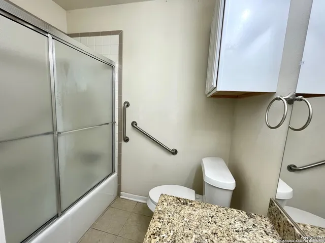a bathroom with a shower a toilet and sink