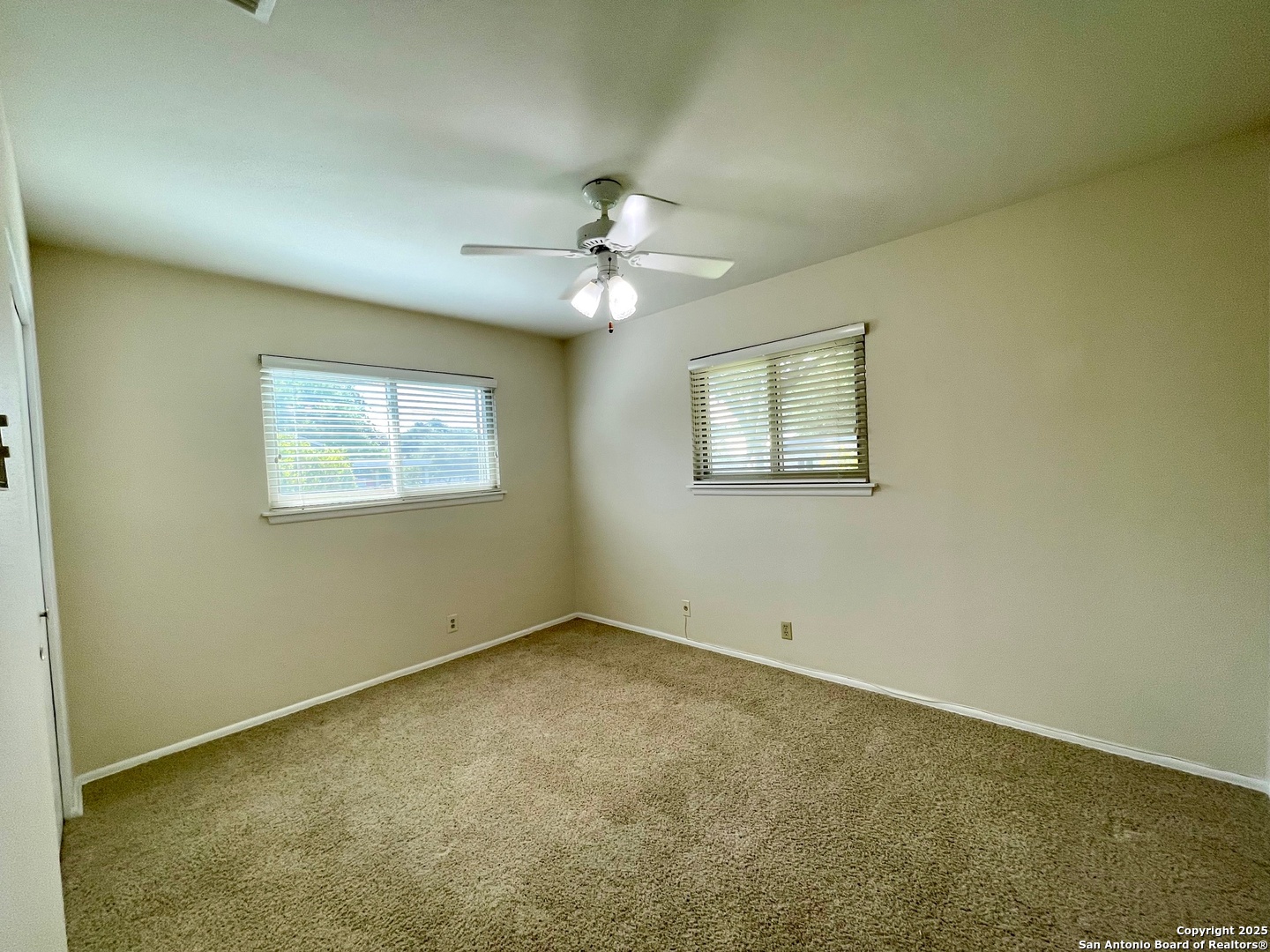 6714 Straw Flower Street Leon Valley, TX 78238 - Photo 19 of 23 an empty room with windows and fan