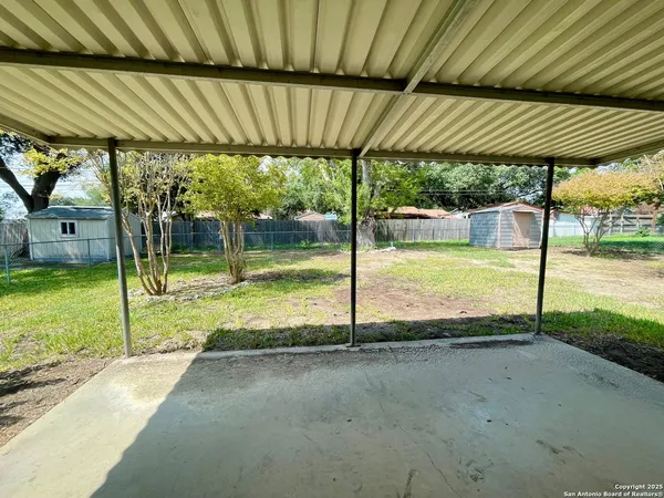 a view of a backyard with swimming pool