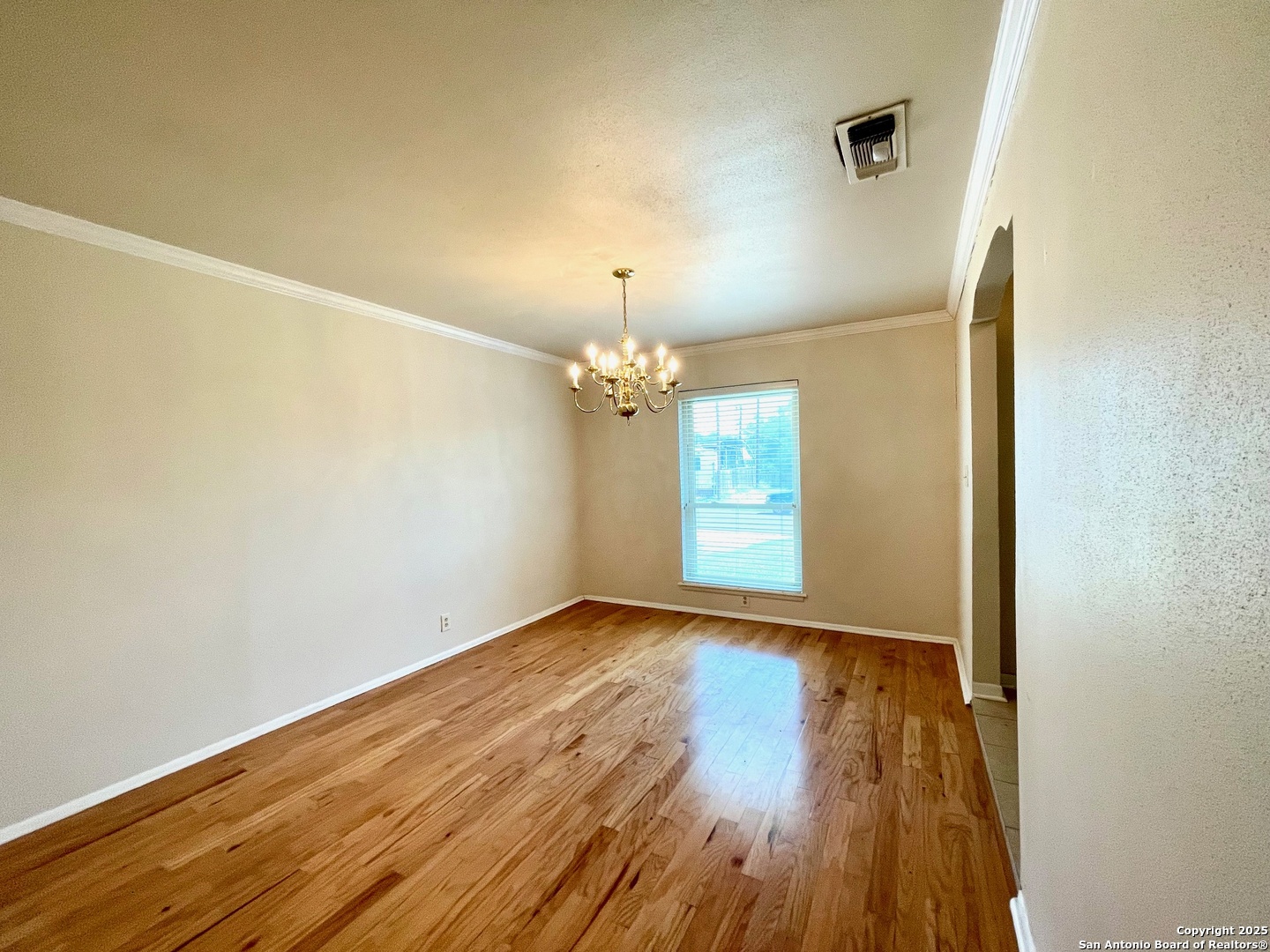 6714 Straw Flower Street Leon Valley, TX 78238 - Photo 5 of 23 wooden floor in an empty room with a window