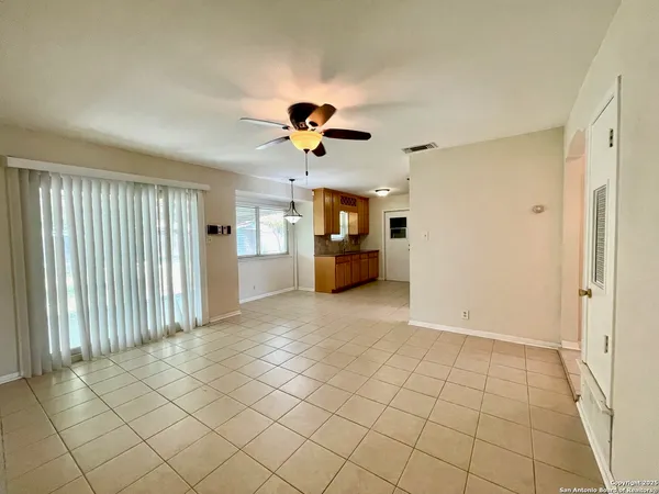 a view of a kitchen with furniture and a ceiling fan