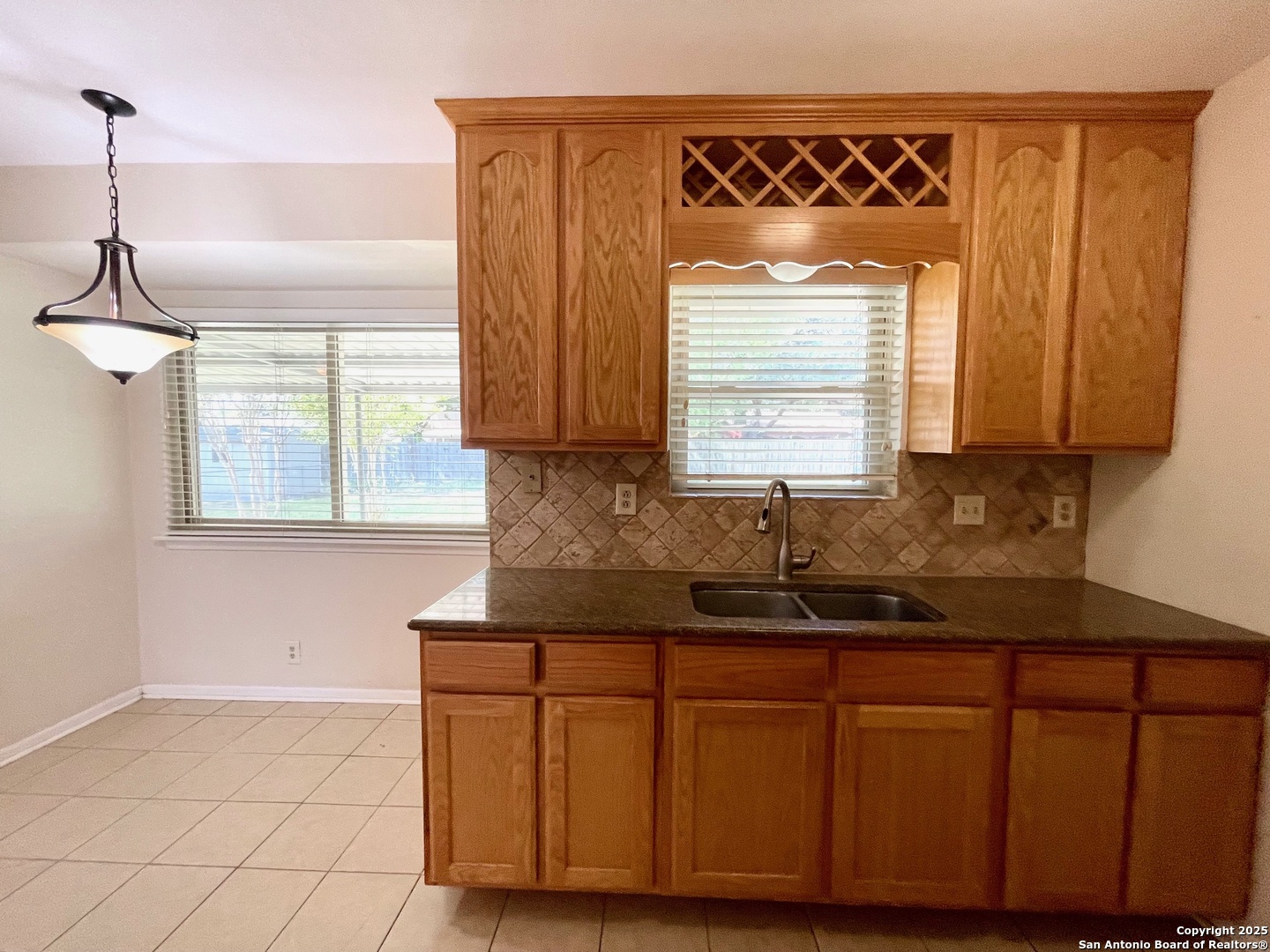 6714 Straw Flower Street Leon Valley, TX 78238 - Photo 10 of 23 a kitchen with granite countertop a sink and a window