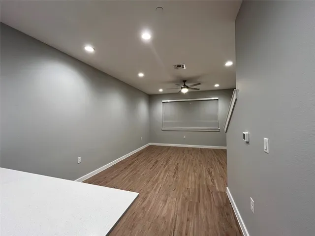 an empty room with wooden floor
