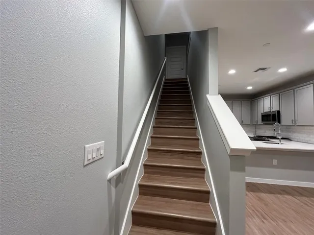 a view of entryway and hall with wooden floor