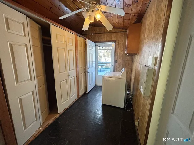 a view of a hallway with wooden floor and stairs