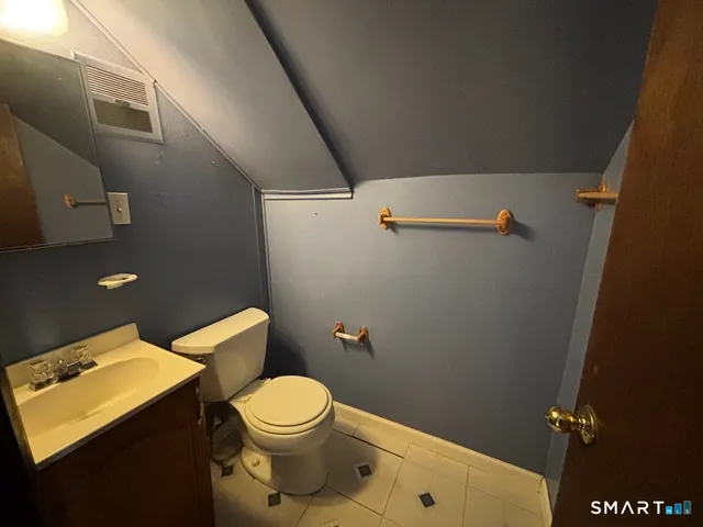 a white toilet sitting next to a bathroom sink