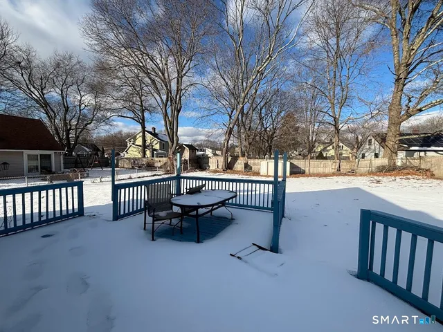 a park view with large trees and wooden fence