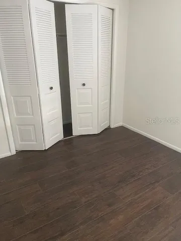 an empty room with wooden floor