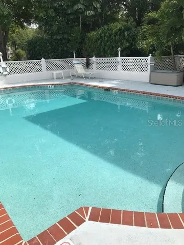 a view of a green field with white walls