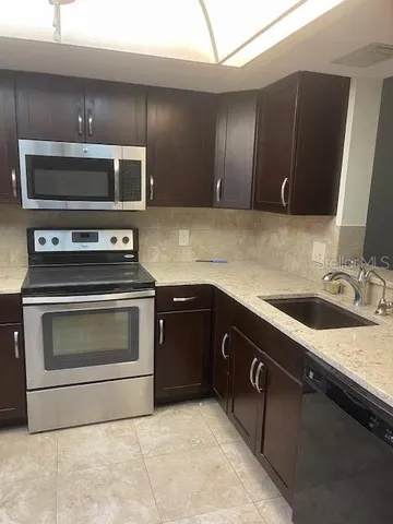 a kitchen with a stove and a sink