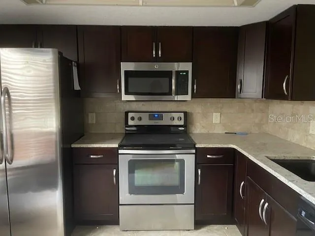 a kitchen with a stove microwave and refrigerator