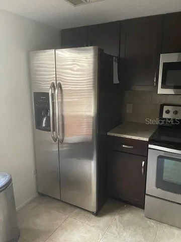 a kitchen with a refrigerator stove and microwave