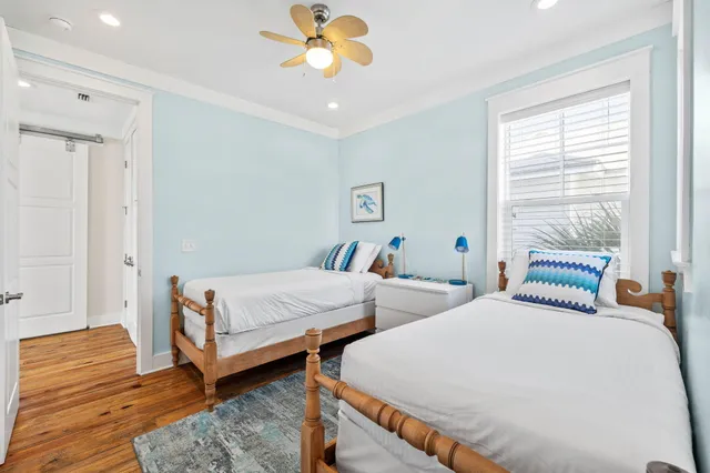 a bedroom with two beds and a chandelier