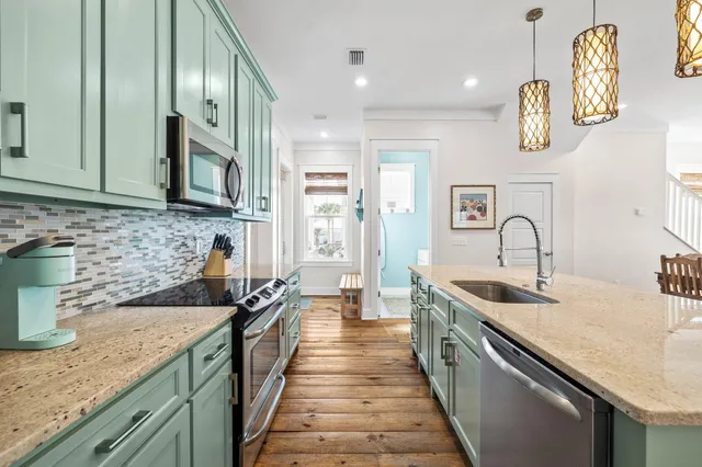 a kitchen with kitchen island granite countertop a sink and stove