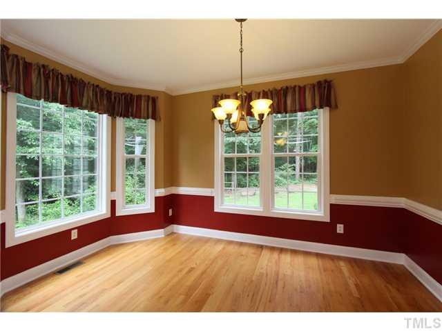 6909 Pinnacle Ridge Road Raleigh, NC 27603 - Photo 7 of 25 Large dining room has lots of windows, chair rail, crown molding, & hardwood floors. Dining Room