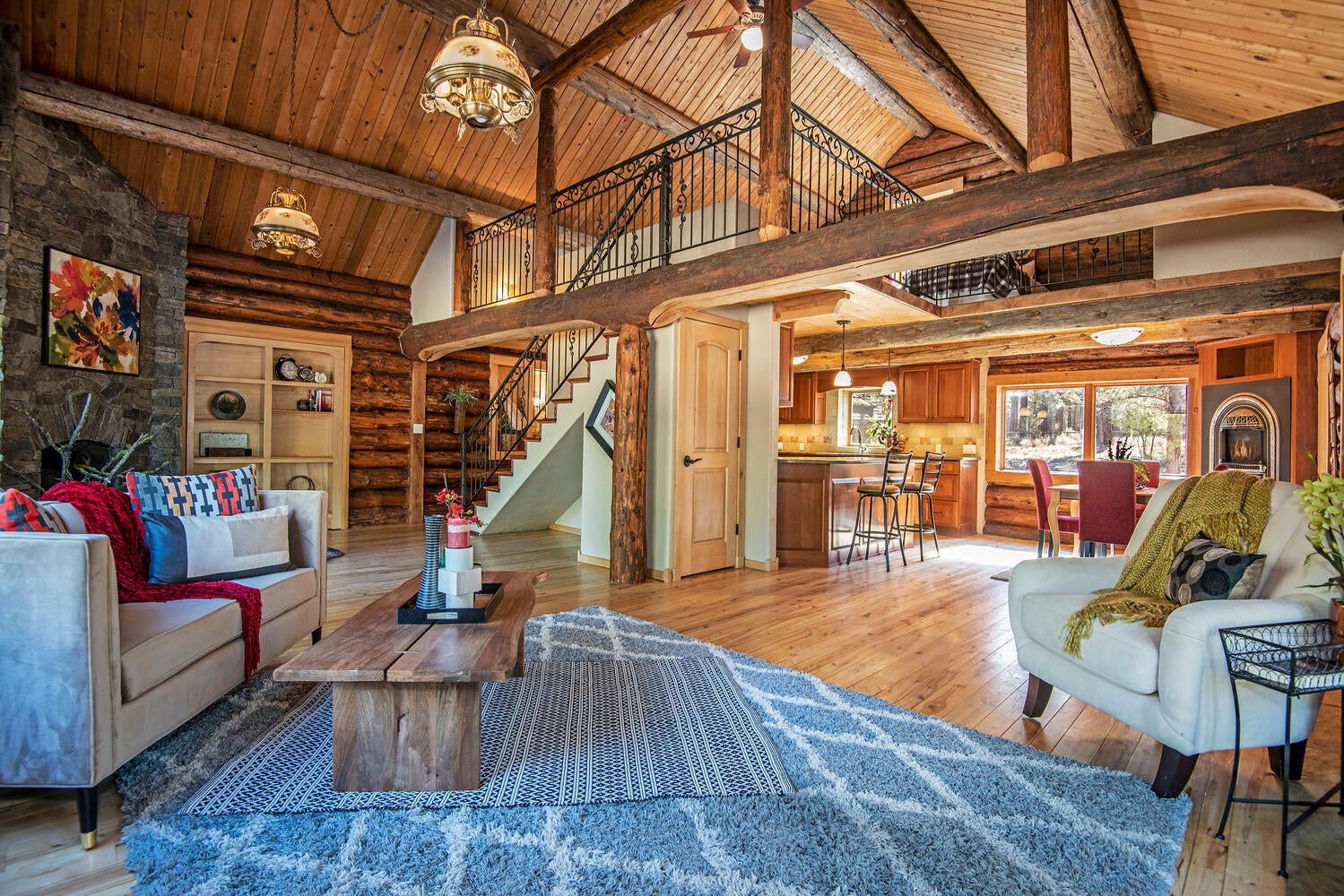Great Room with Vaulted Ceilings, Hickory Floors, Hand Hewn Logs, and View to Loft