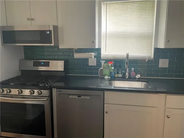 a kitchen with a sink and cabinets