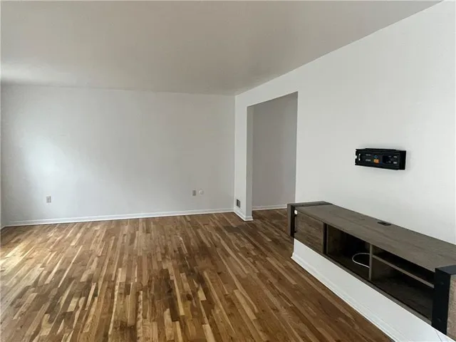 a view of wooden floor and brick walls