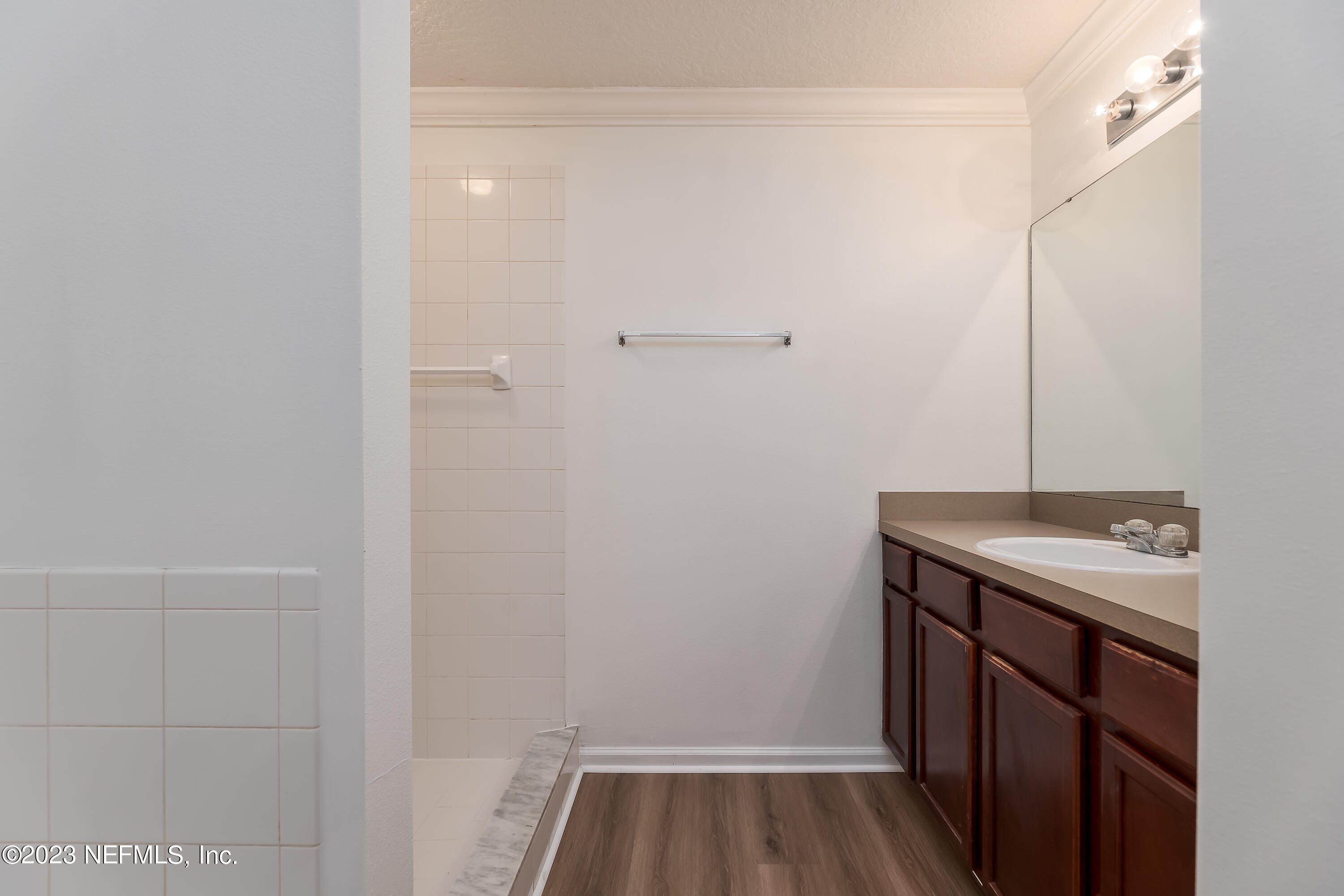 5260 Collins Road, Unit 1102 Jacksonville, FL 32244 - Photo 11 of 23 a bathroom with a sink and vanity
