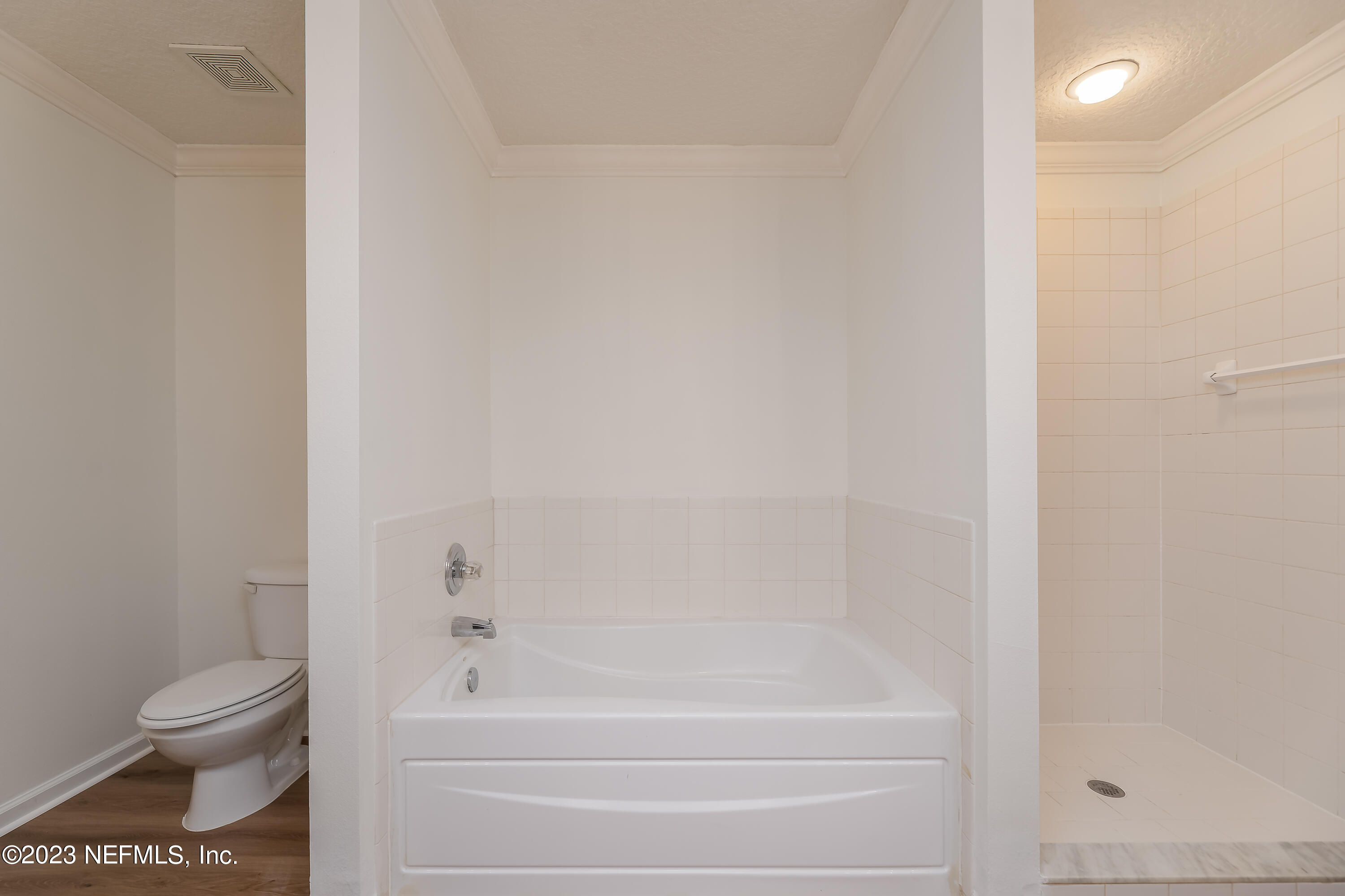 5260 Collins Road, Unit 1102 Jacksonville, FL 32244 - Photo 12 of 23 a bathroom with a toilet and a bathtub