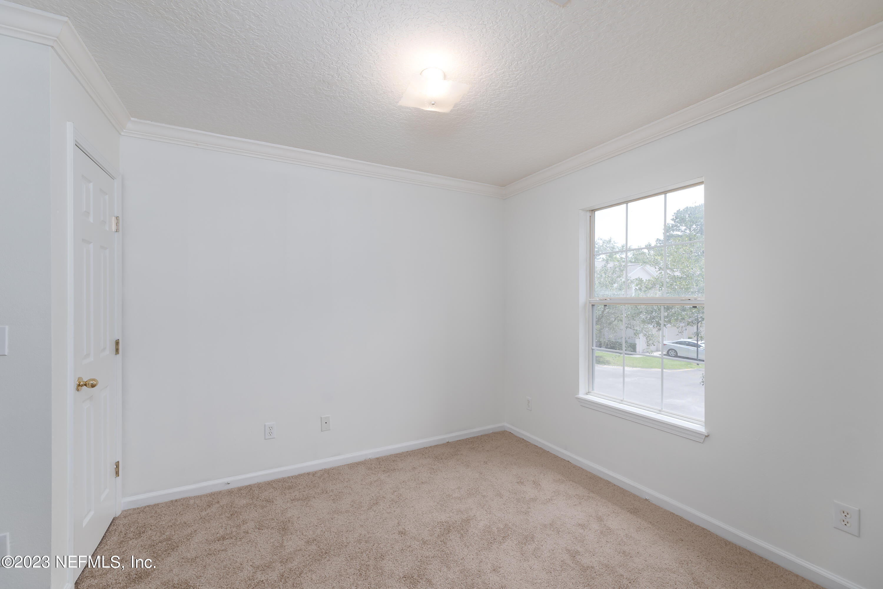 5260 Collins Road, Unit 1102 Jacksonville, FL 32244 - Photo 13 of 23 an empty room with a window
