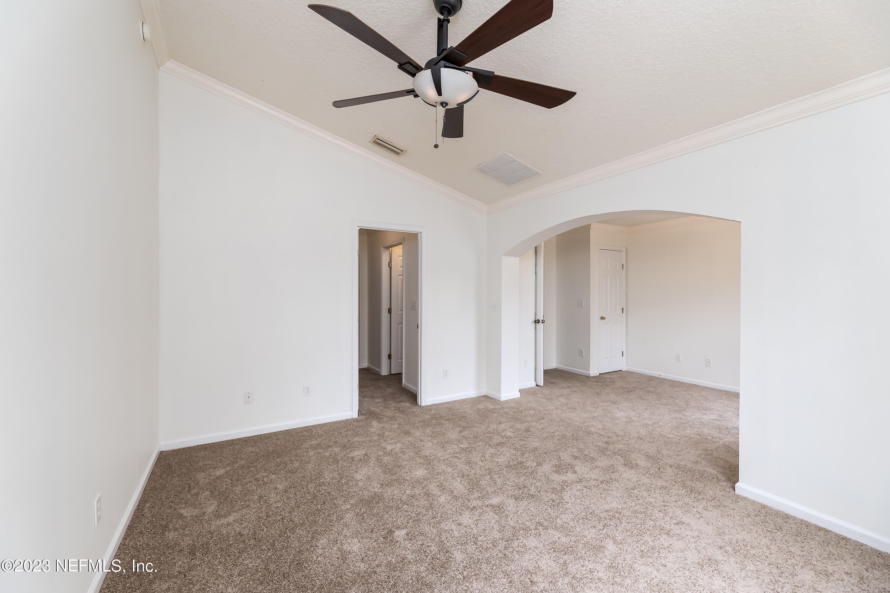 5260 Collins Road, Unit 1102 Jacksonville, FL 32244 - Photo 15 of 23 an empty room with a ceiling fan and carpet