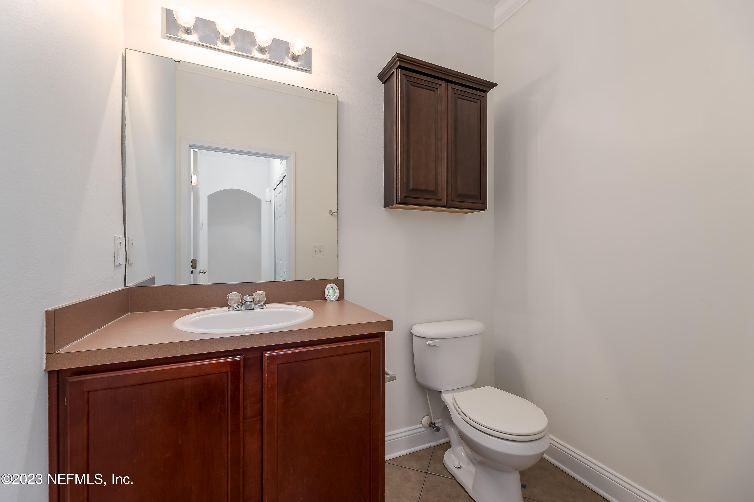 5260 Collins Road, Unit 1102 Jacksonville, FL 32244 - Photo 4 of 23 a bathroom with a toilet sink and mirror