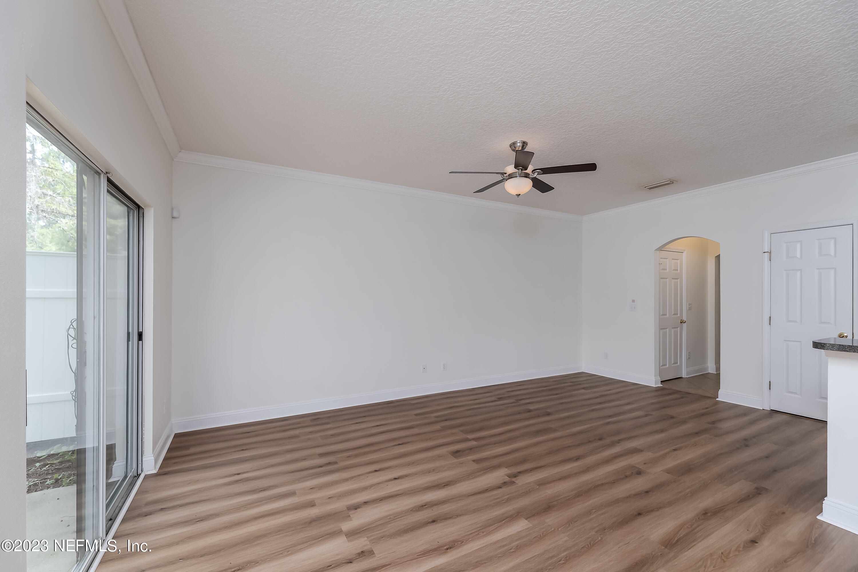 5260 Collins Road, Unit 1102 Jacksonville, FL 32244 - Photo 5 of 23 wooden floor in an empty room with a window