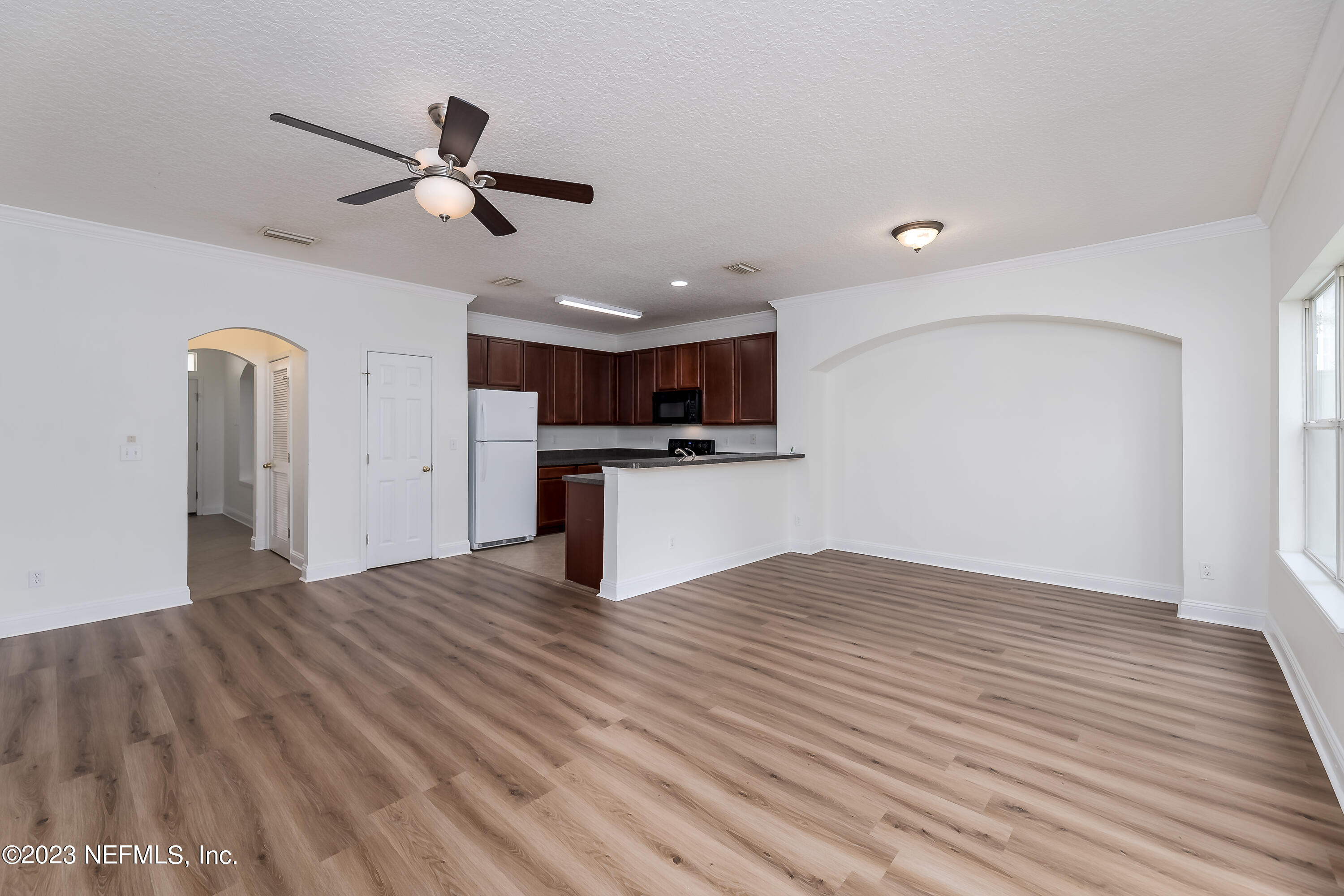 5260 Collins Road, Unit 1102 Jacksonville, FL 32244 - Photo 6 of 23 a view of a kitchen with a sink and wooden floor