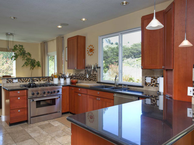 104 Nataqua Avenue Pacifica, CA 94044 - Photo 11 of 17 a kitchen with stainless steel appliances granite countertop a stove a sink and a microwave