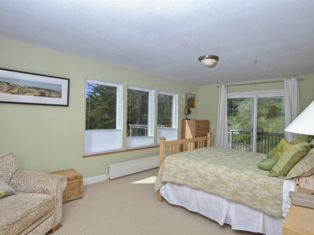 104 Nataqua Avenue Pacifica, CA 94044 - Photo 13 of 17 a bedroom with a bed and glass window