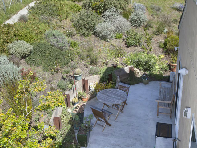 104 Nataqua Avenue Pacifica, CA 94044 - Photo 5 of 17 a backyard of a house with table and chairs