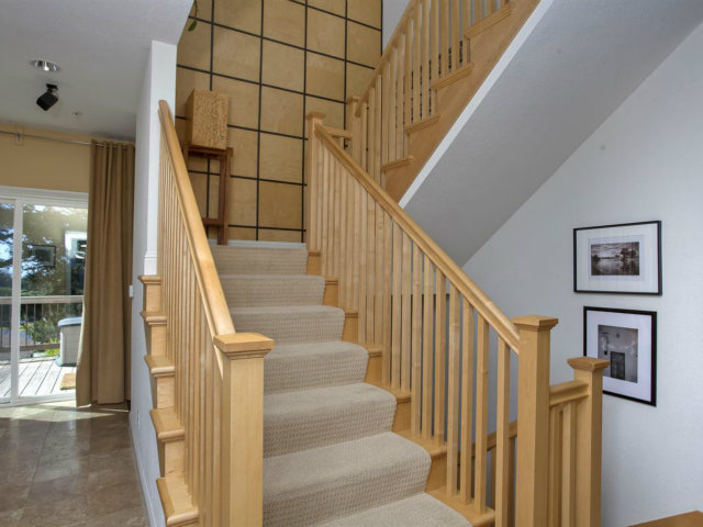 104 Nataqua Avenue Pacifica, CA 94044 - Photo 7 of 17 a view of staircase with lots of frames on wall and a window