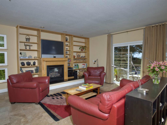 104 Nataqua Avenue Pacifica, CA 94044 - Photo 8 of 17 a living room with furniture fireplace and a flat screen tv