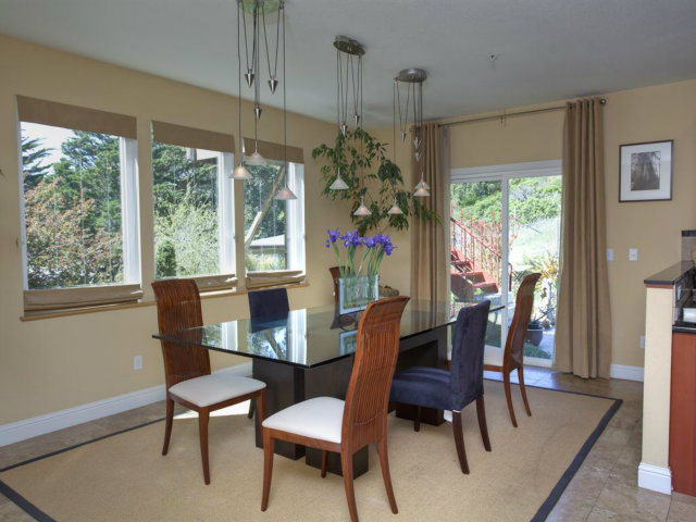 104 Nataqua Avenue Pacifica, CA 94044 - Photo 10 of 17 a dining room with furniture a chandelier and wooden floor