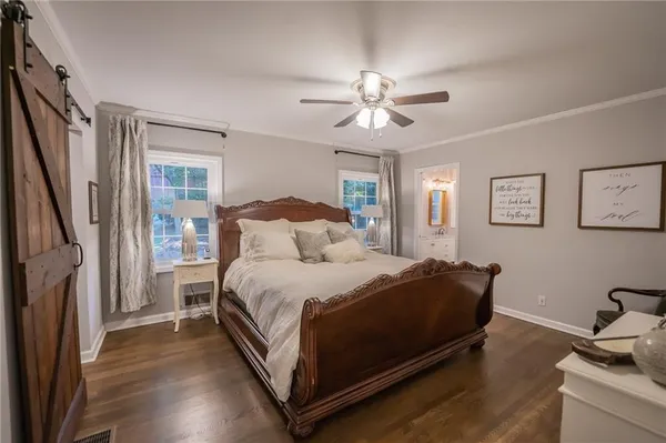 a spacious bedroom with a bed and a chandelier