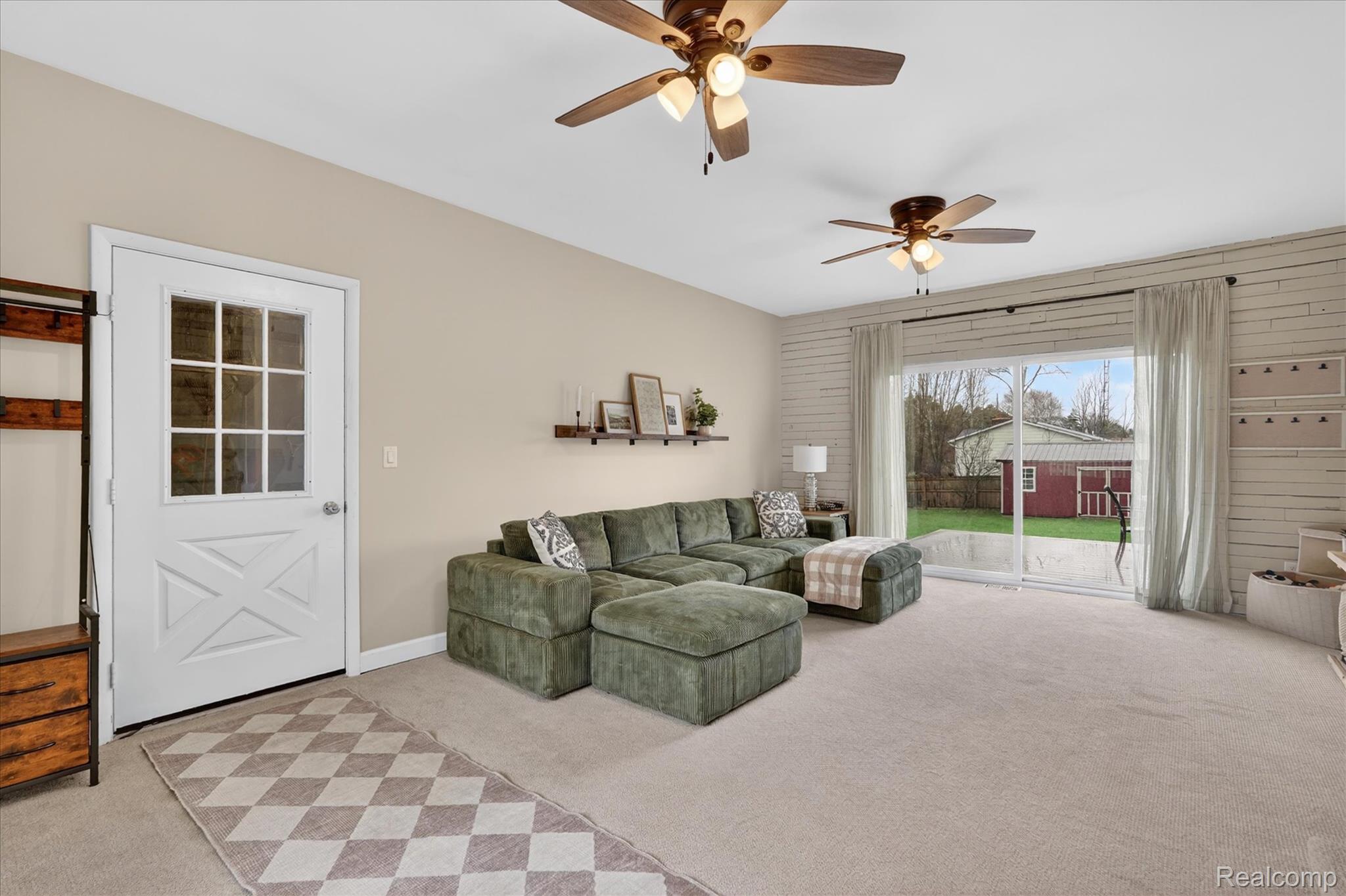 13508 North Center Road Clio, MI 48420 - Photo 9 of 38 Living room featuring light carpet and ceiling fan