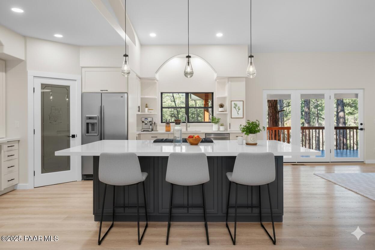 345 Banning Creek Road Prescott, AZ 86303 - Photo 12 of 41 a kitchen with stainless steel appliances a dining table chairs and wooden floor