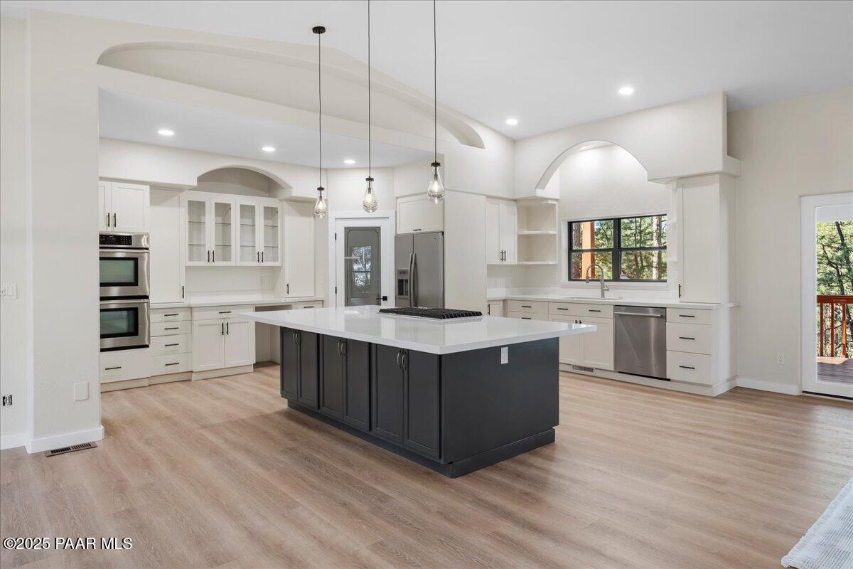 345 Banning Creek Road Prescott, AZ 86303 - Photo 13 of 41 a large kitchen with stainless steel appliances granite countertop a large center island a sink a stove and a wooden floors