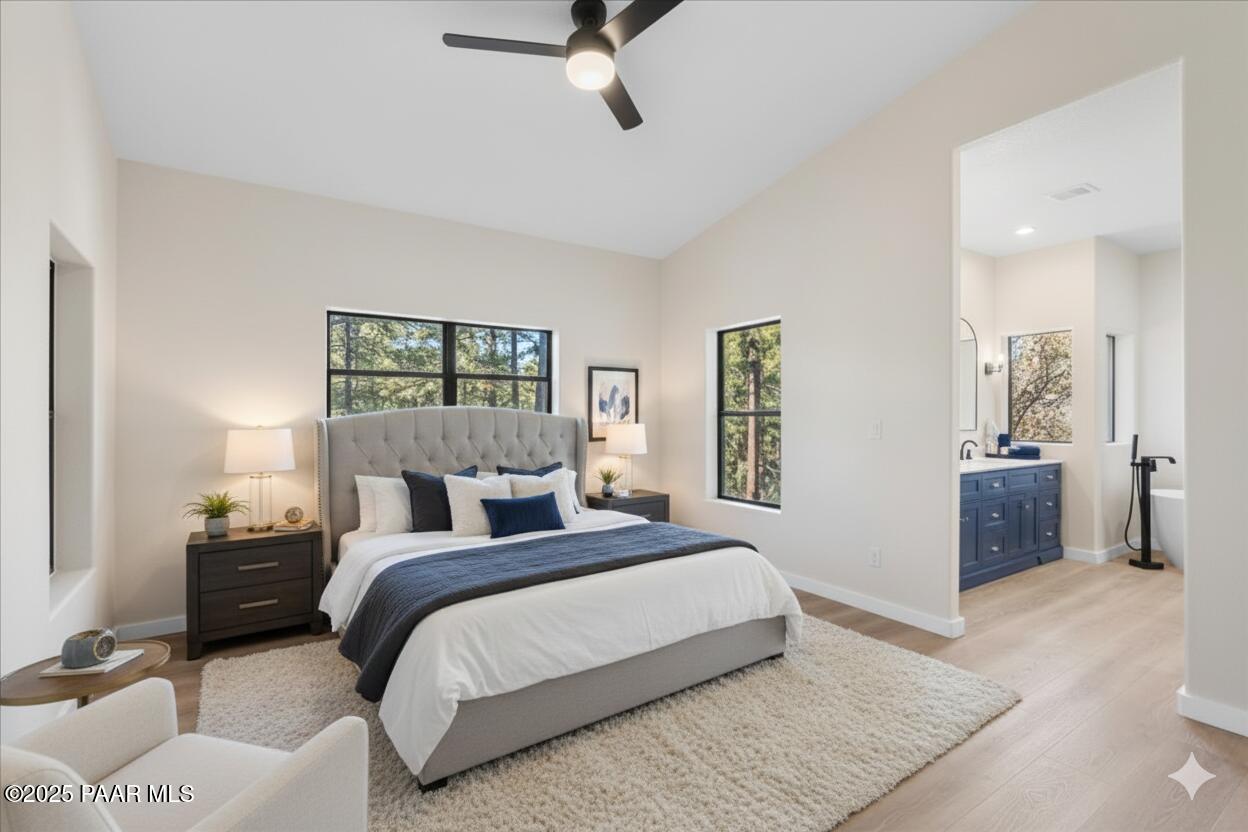 345 Banning Creek Road Prescott, AZ 86303 - Photo 18 of 41 a bedroom with a large bed and a chandelier