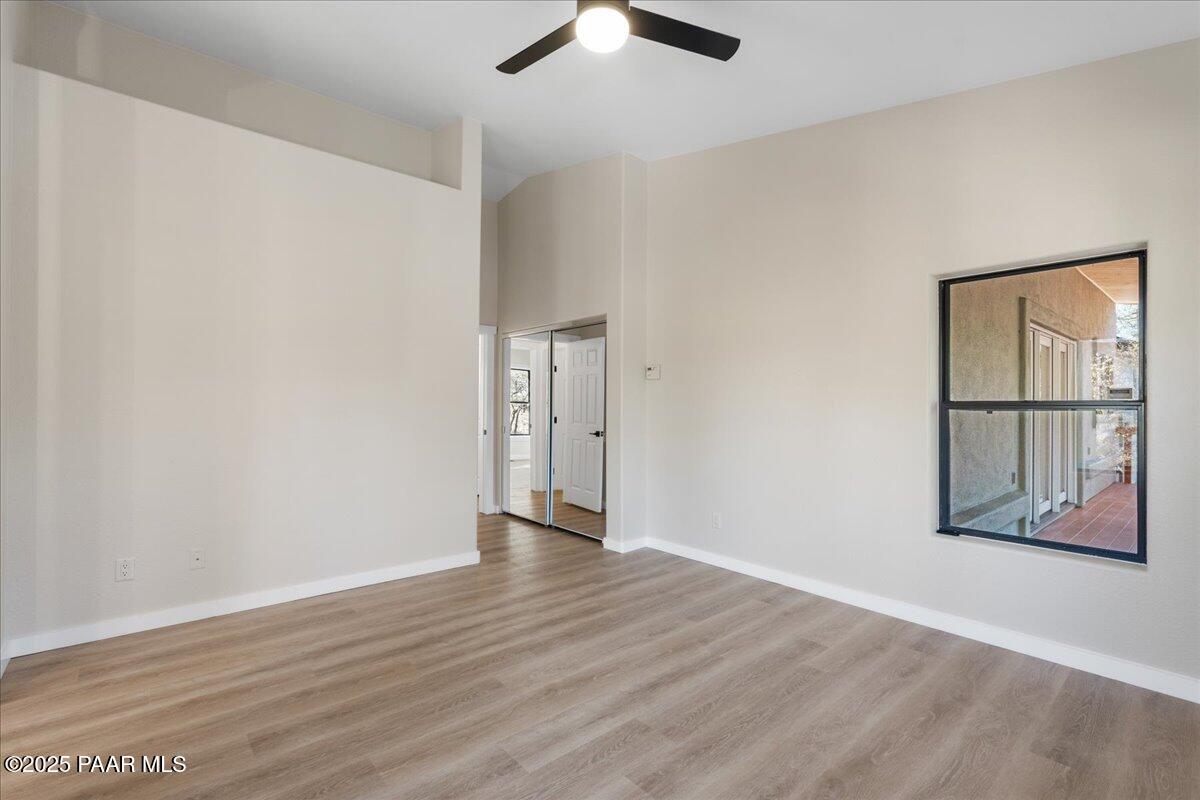 345 Banning Creek Road Prescott, AZ 86303 - Photo 19 of 41 an empty room with wooden floor and windows