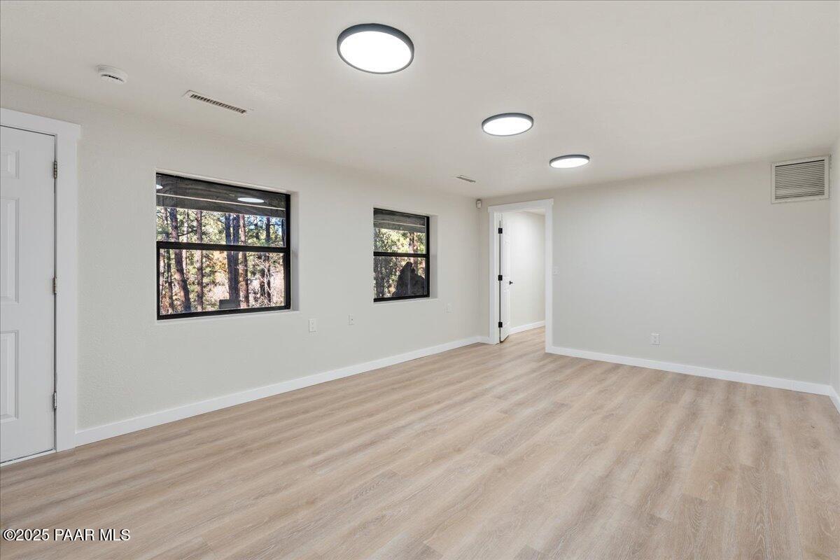 345 Banning Creek Road Prescott, AZ 86303 - Photo 30 of 41 wooden floor in an empty room with a window