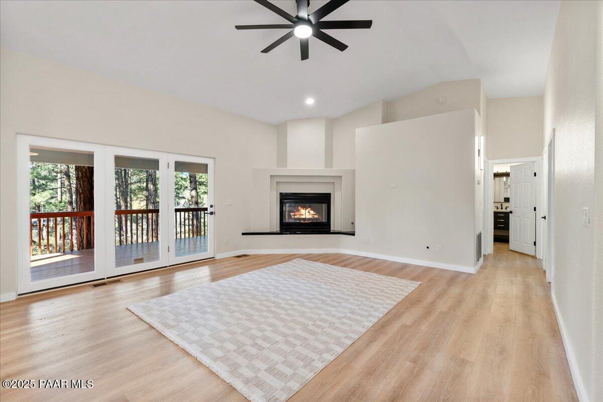 345 Banning Creek Road Prescott, AZ 86303 - Photo 9 of 41 a view of an empty room with window and wooden floor