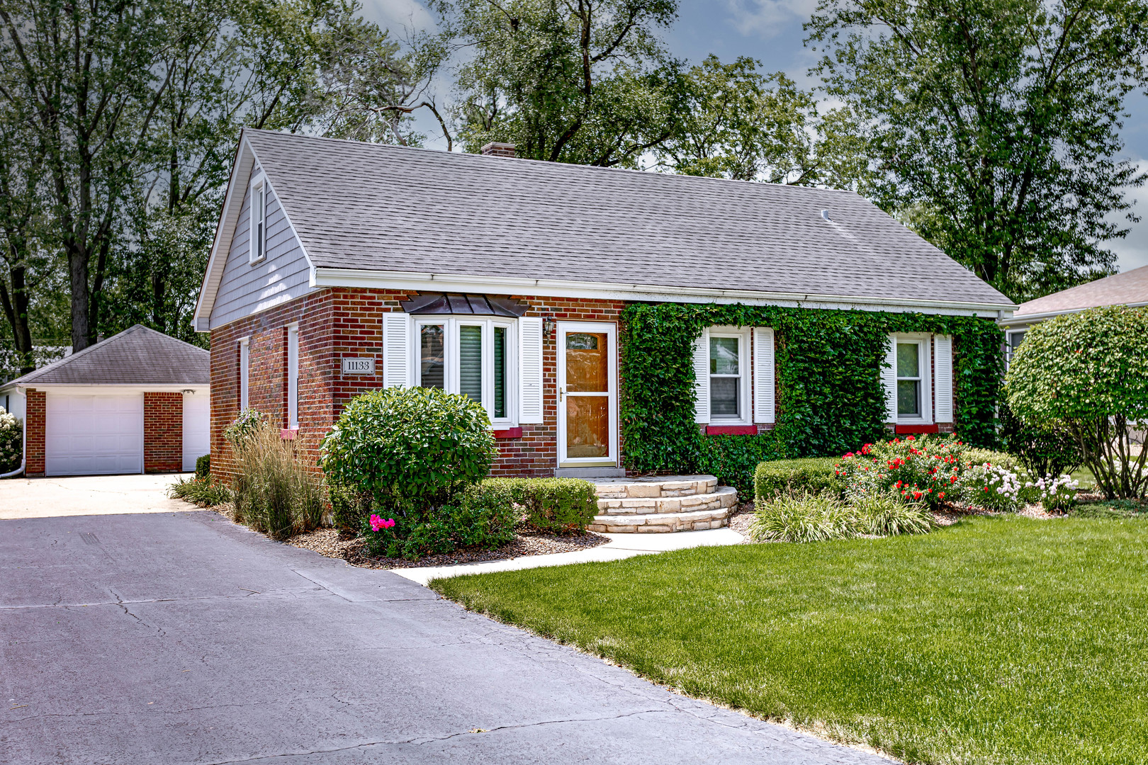 a front view of house with yard and green space