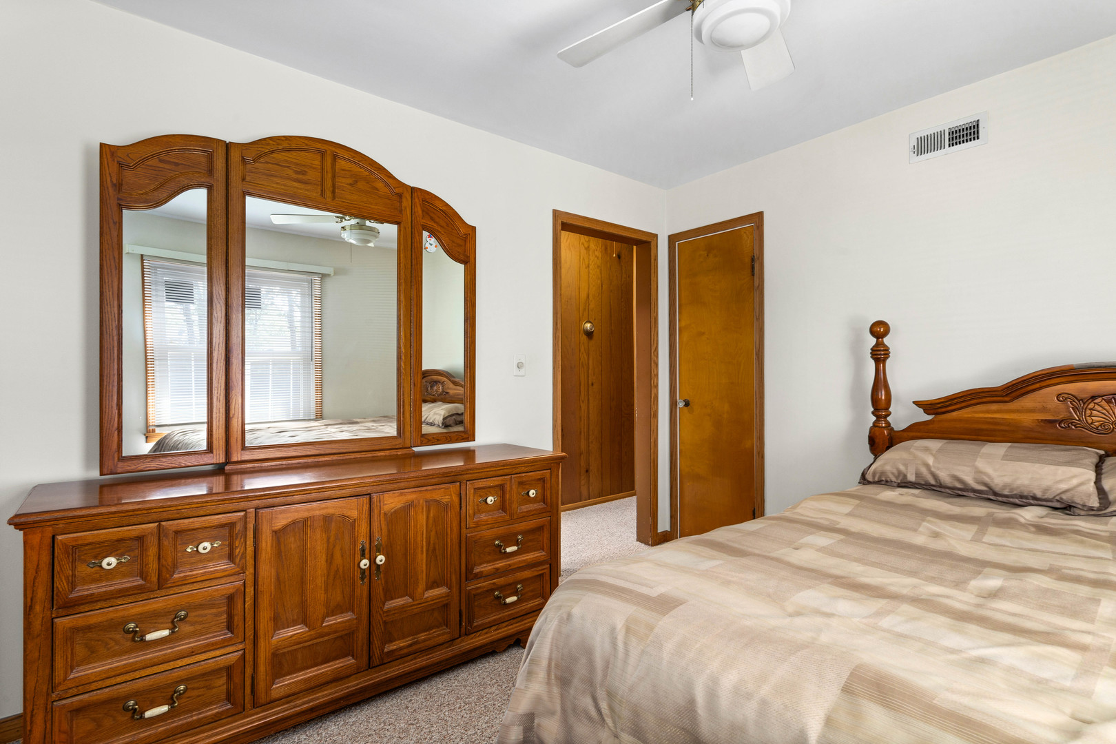 11133 Revere Road Mokena, IL 60448 - Photo 14 of 22 a bedroom with a bed and a mirror on the dresser